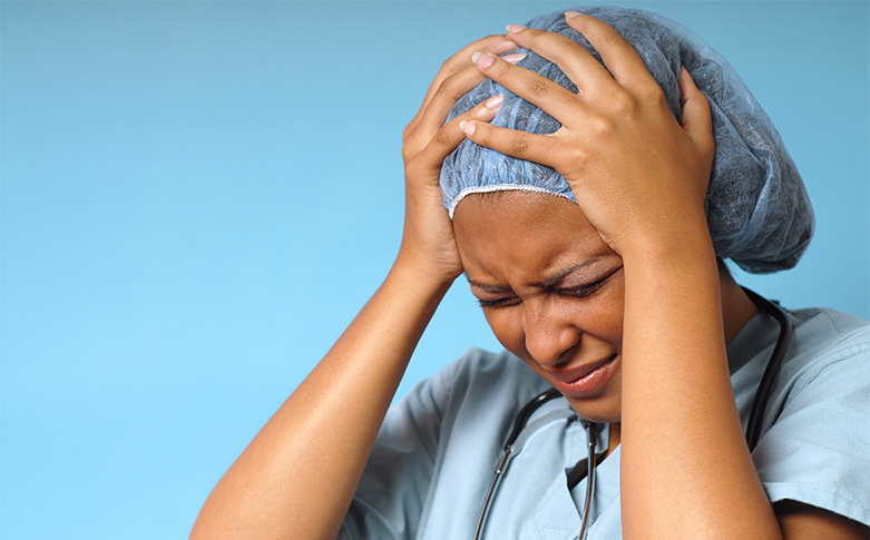 Young nurse stressed out and upset at work