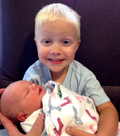 Kyron holding his little brother at Nebraska Medicine.