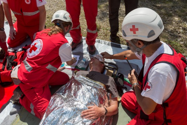 Sofia, Bulgaria - May 19, 2015: Volunteers from Bulgarian Red Cross organization are participating in a training with Fire department. They are assisting first aid to people involved in a train crash accident.